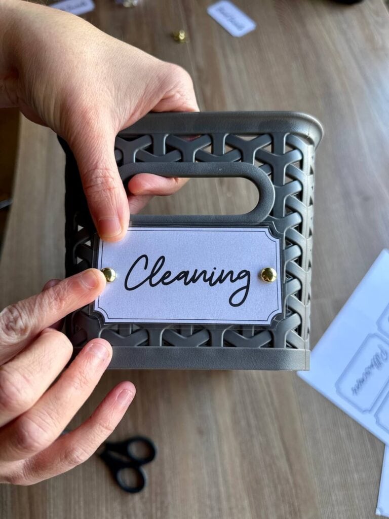 attaching a label to a basket with brad fasteners