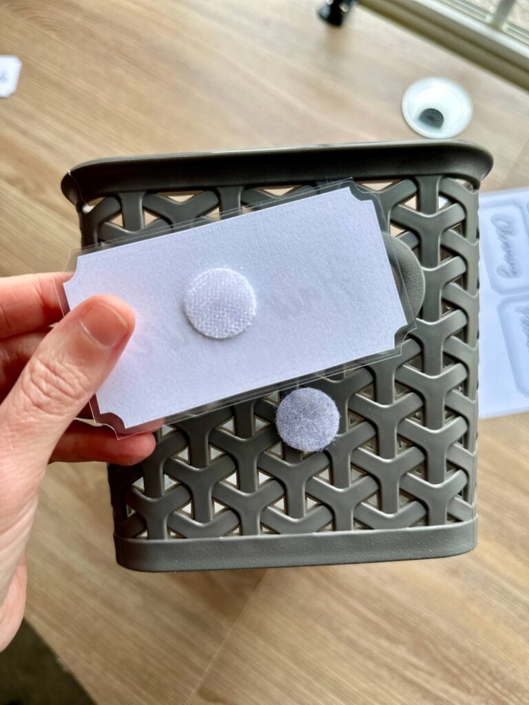 using velcro circle stickers to attach labels to organizing baskets