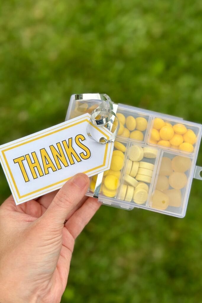 yellow plastic candy box with gift tag that says thanks
