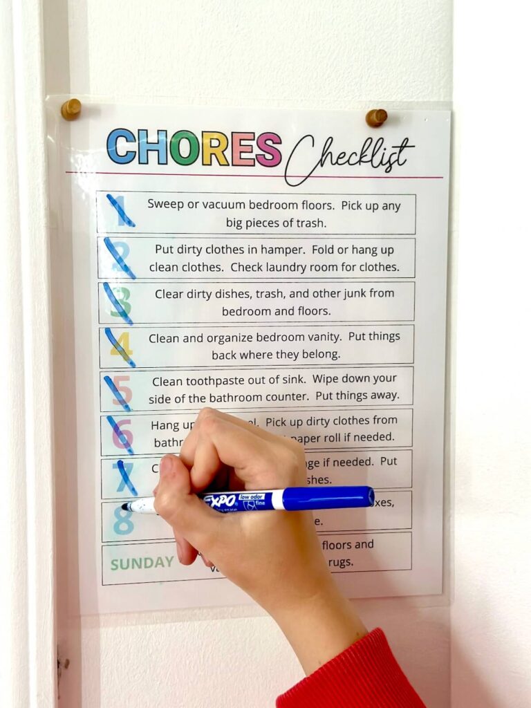 teenager checking things off a chore chart