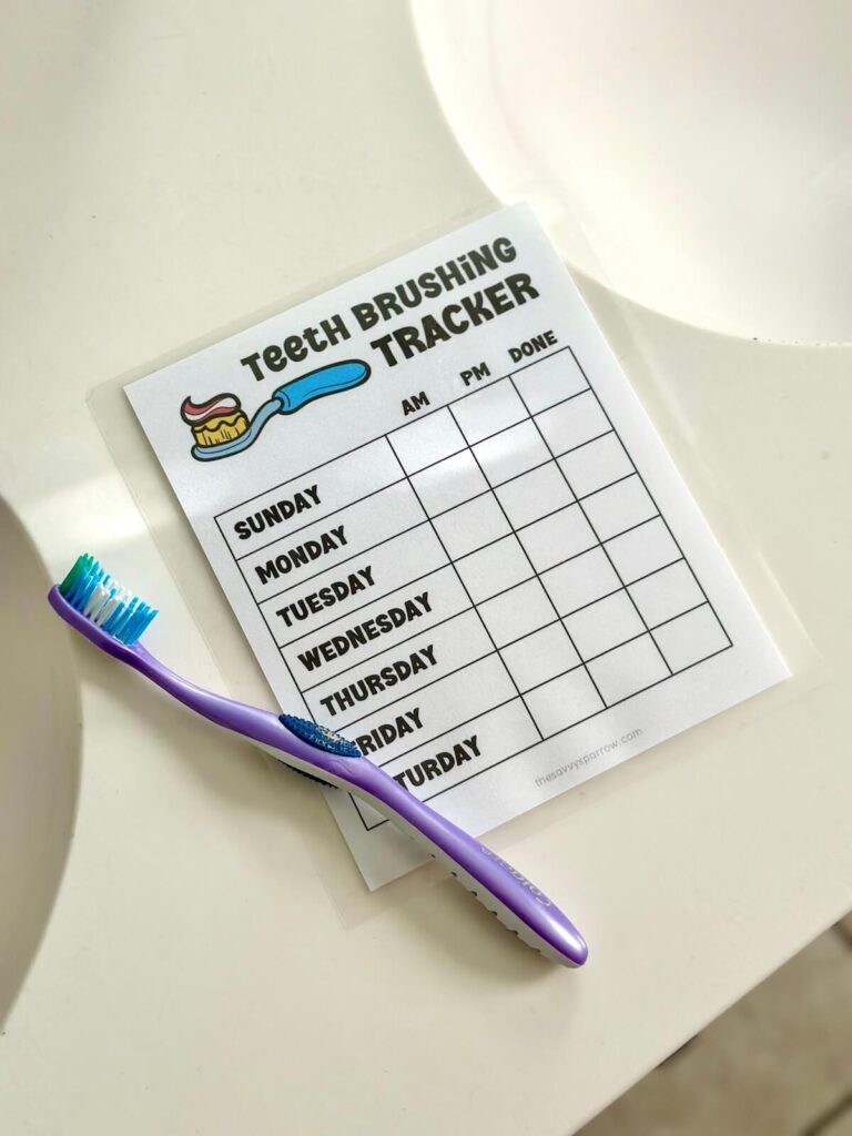 free printable tooth brushing chart on a bathroom counter