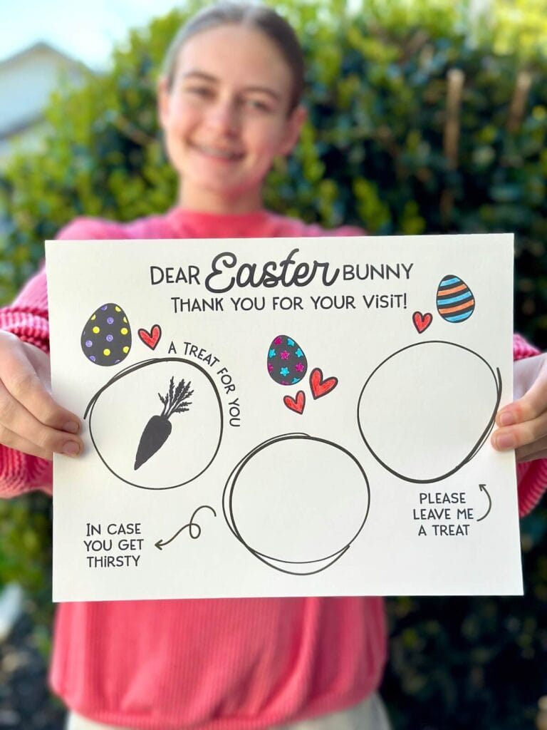 girl holding a placemat for treats for the Easter Bunny