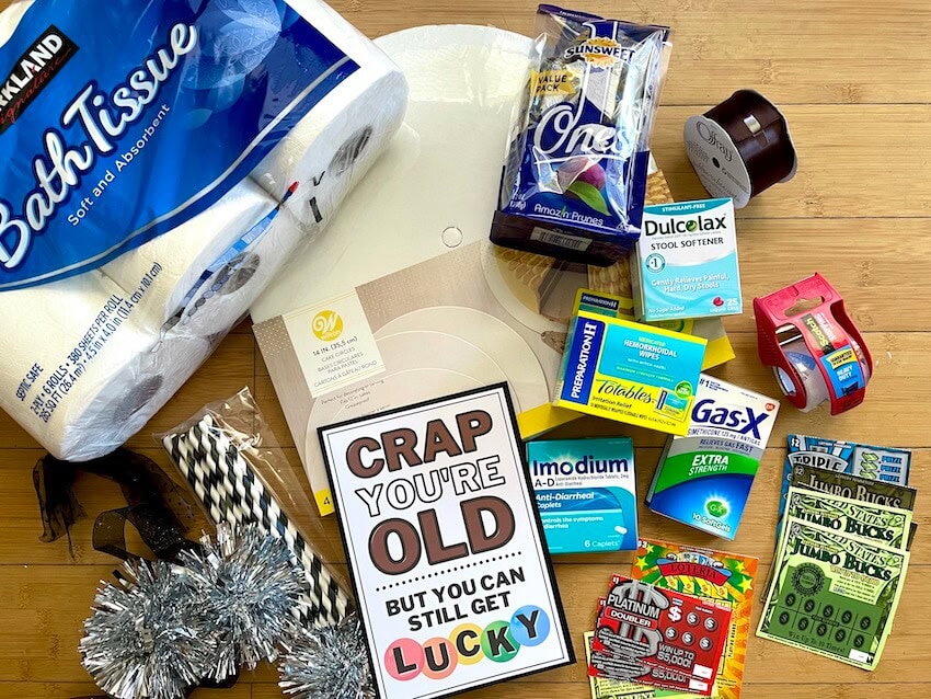 toilet paper, Over the Hill gag gift tag, lottery tickets, and tape