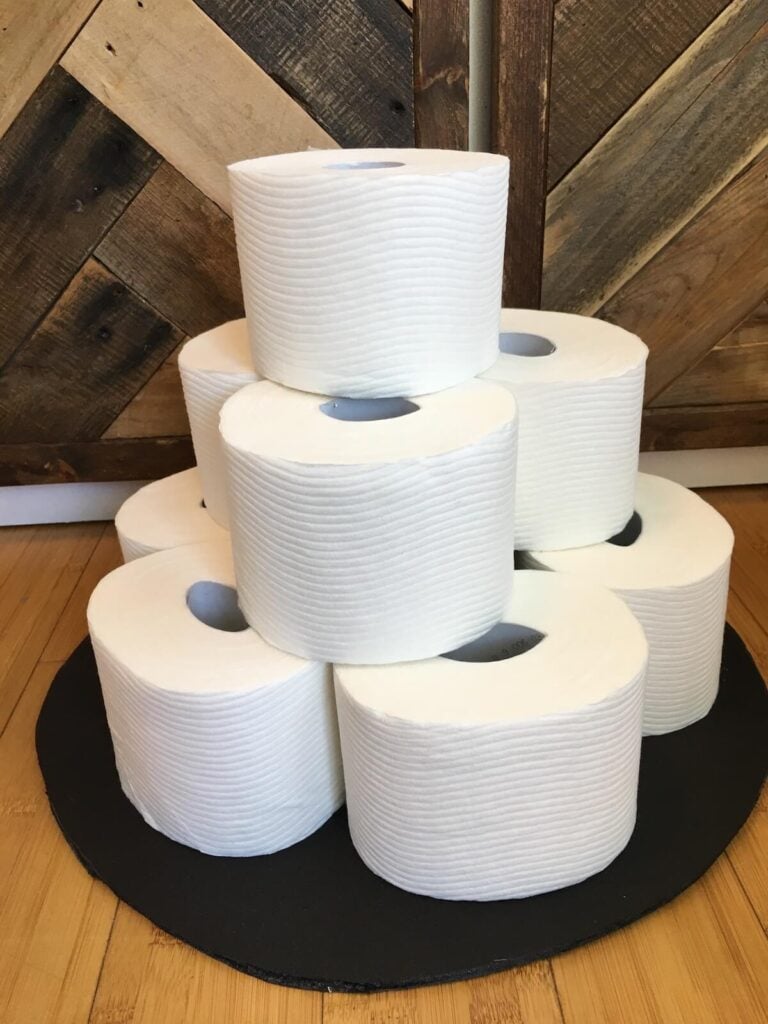 toilet paper stacked up for a toilet paper cake