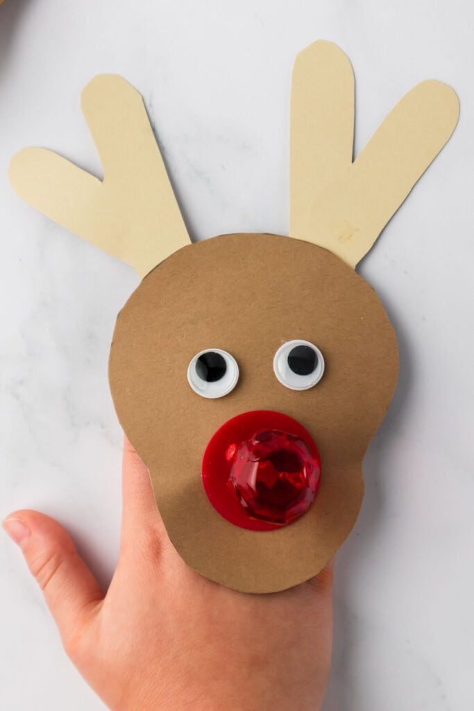 Rudolph craft made with construction paper and a ring pop