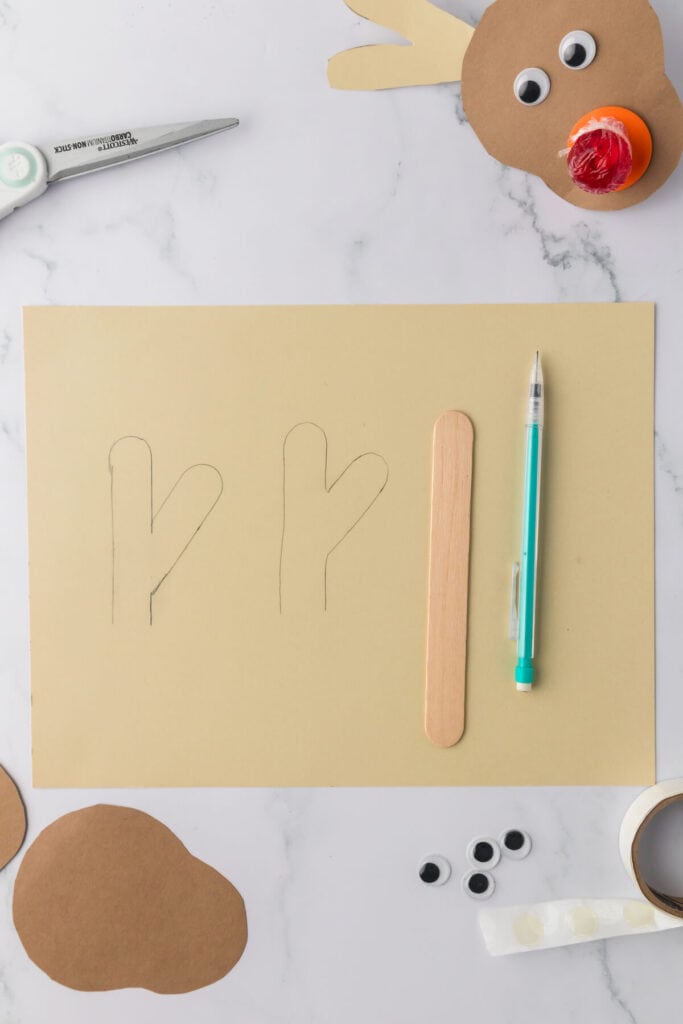 tracing a wooden craft stick to look like antlers
