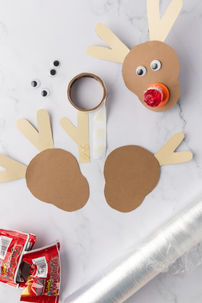 gluing paper antlers on a Rudolph the reindeer craft