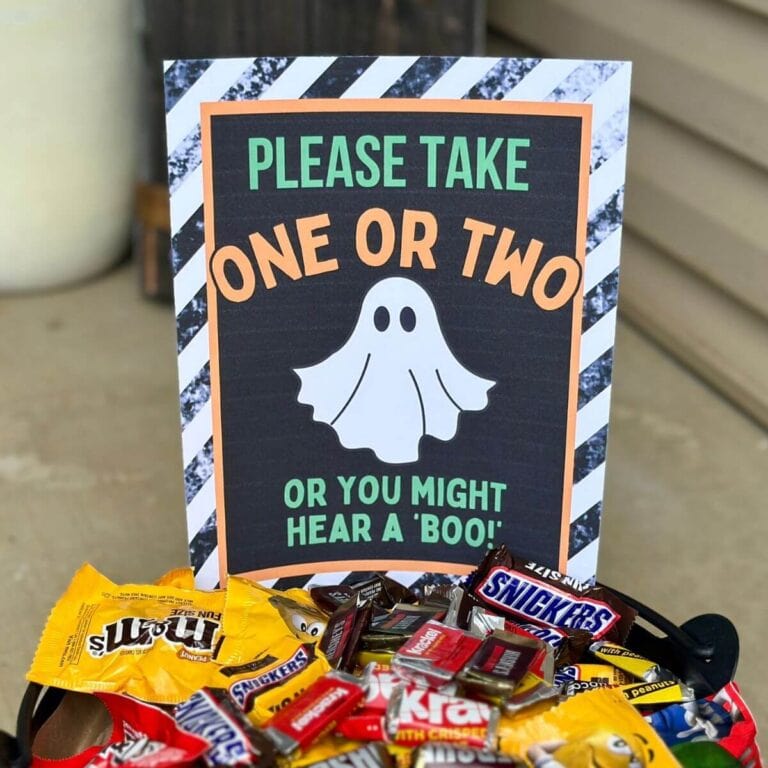 please take one Halloween sign in a candy bowl