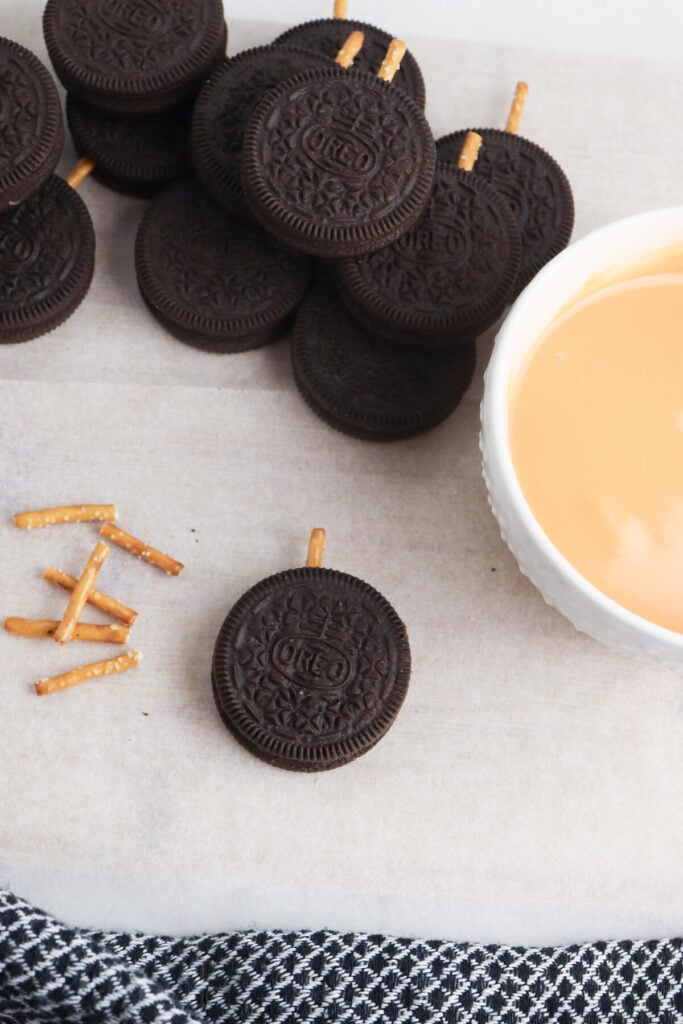 pretzel stick in the side of an Oreo cookie