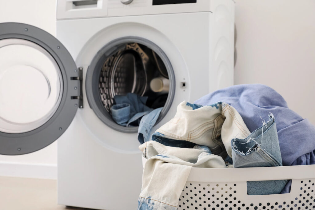 washing machine and laundry basket with clothes