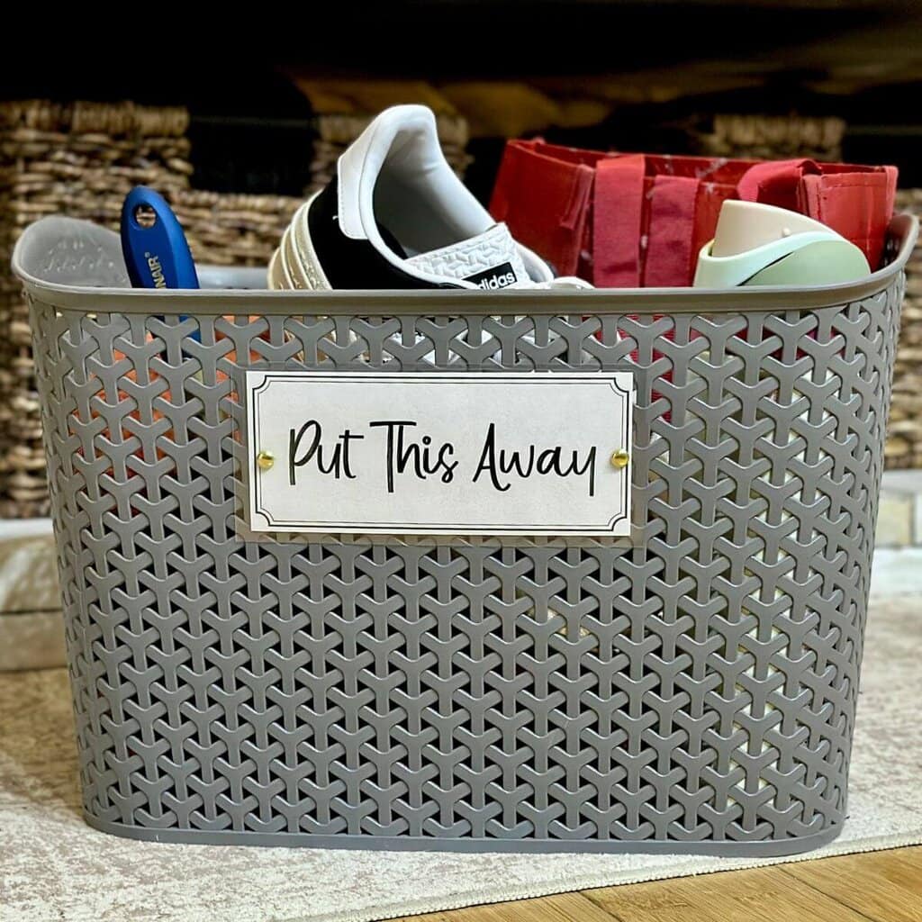 magic basket filled with stuff to clean up with a label that says "put this away"