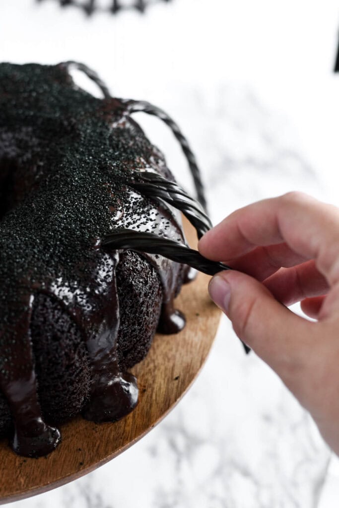inserting licorice into a spider bundt cake