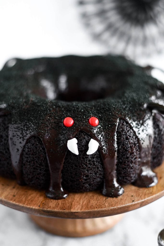candy eyes and marshmallow fangs on a spider bundt cake