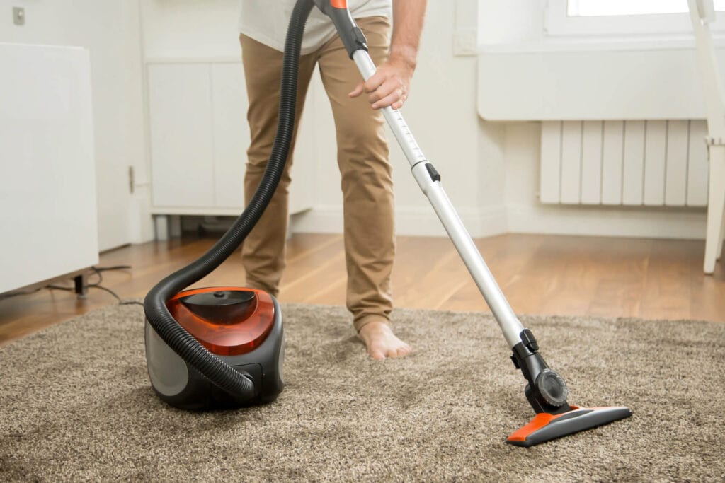 teen vacuuming the house