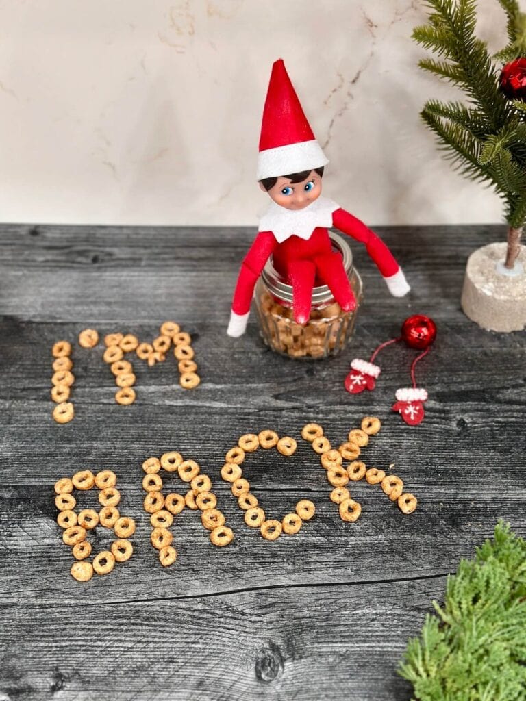 elf with "I'm back" written in Cheerios