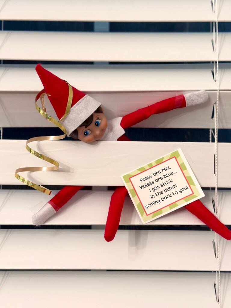 Elf on the shelf stuck in the blinds