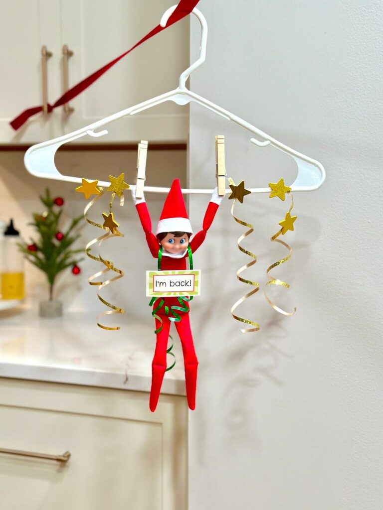 Elf on the Shelf ziplining in on a coat hanger