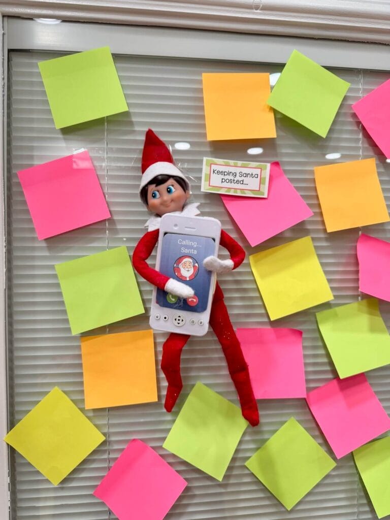 Elf on the Shelf with post-it notes and a play phone that says calling santa