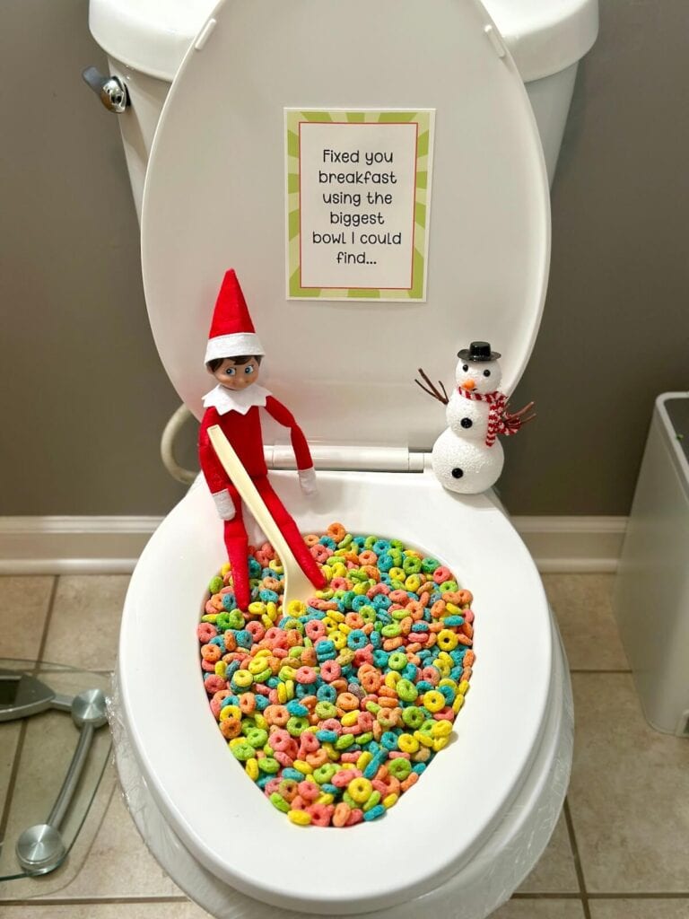 Elf on the Shelf with cereal in a toilet bowl