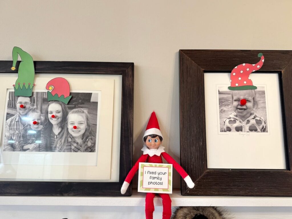 Elf on the Shelf sitting next to family photos with red noses glued on them