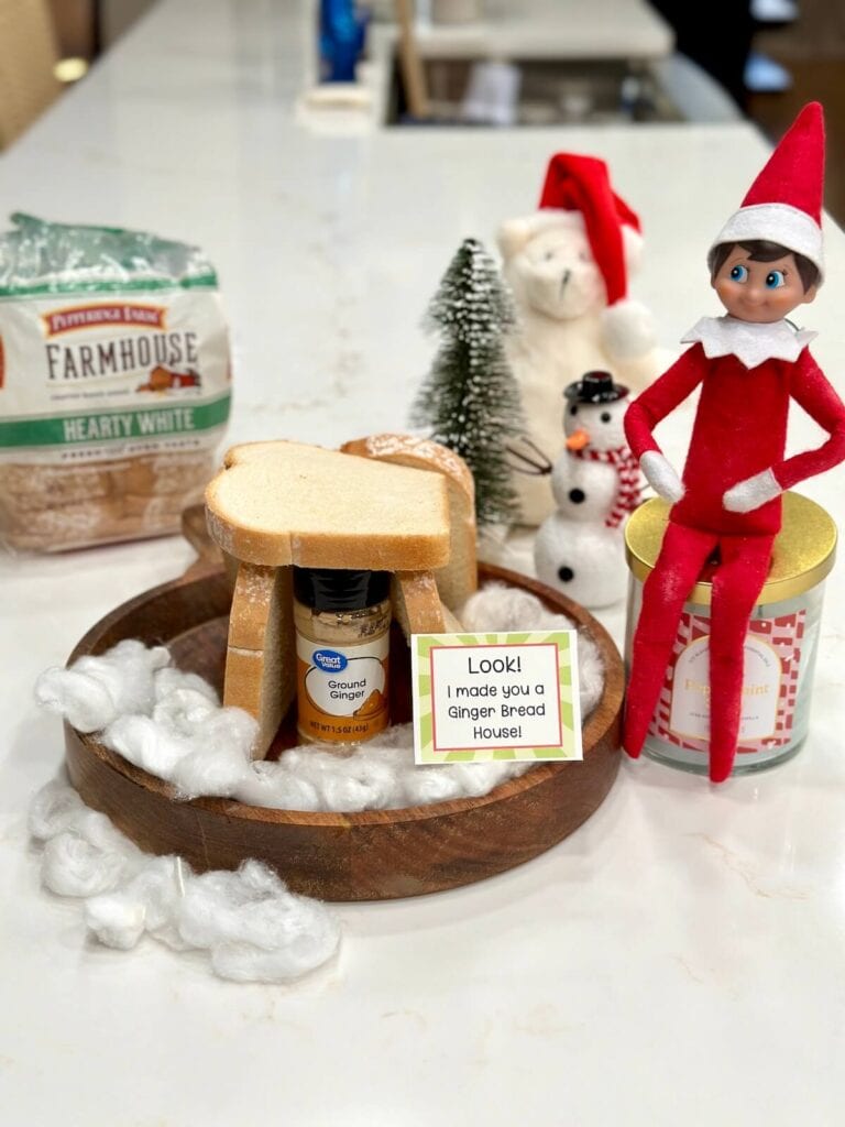 elf making a ginger bread house with a jar of ginger and slices of bread