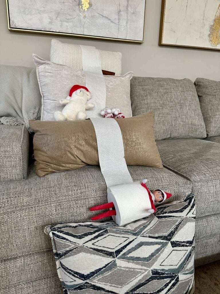 Elf on the Shelf rolling down the couch