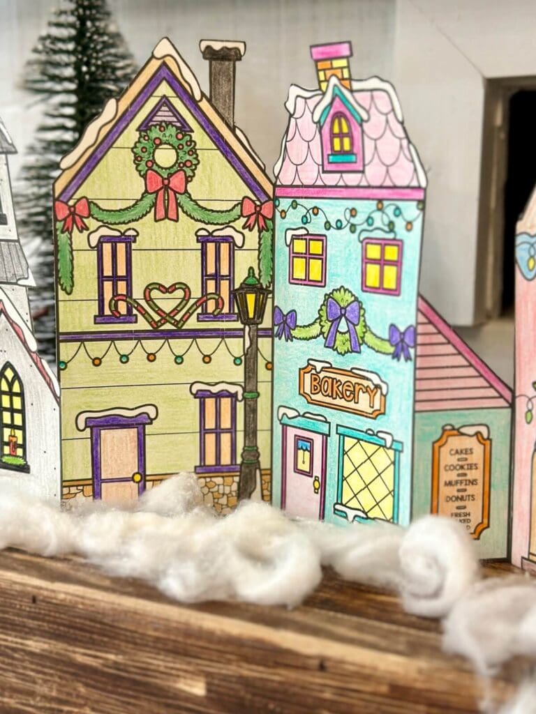 Colorful holiday-themed paper house decorations for Christmas or seasonal decor.