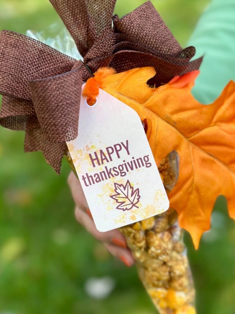 Happy Thanksgiving gift tag tied on a bag of caramel corn