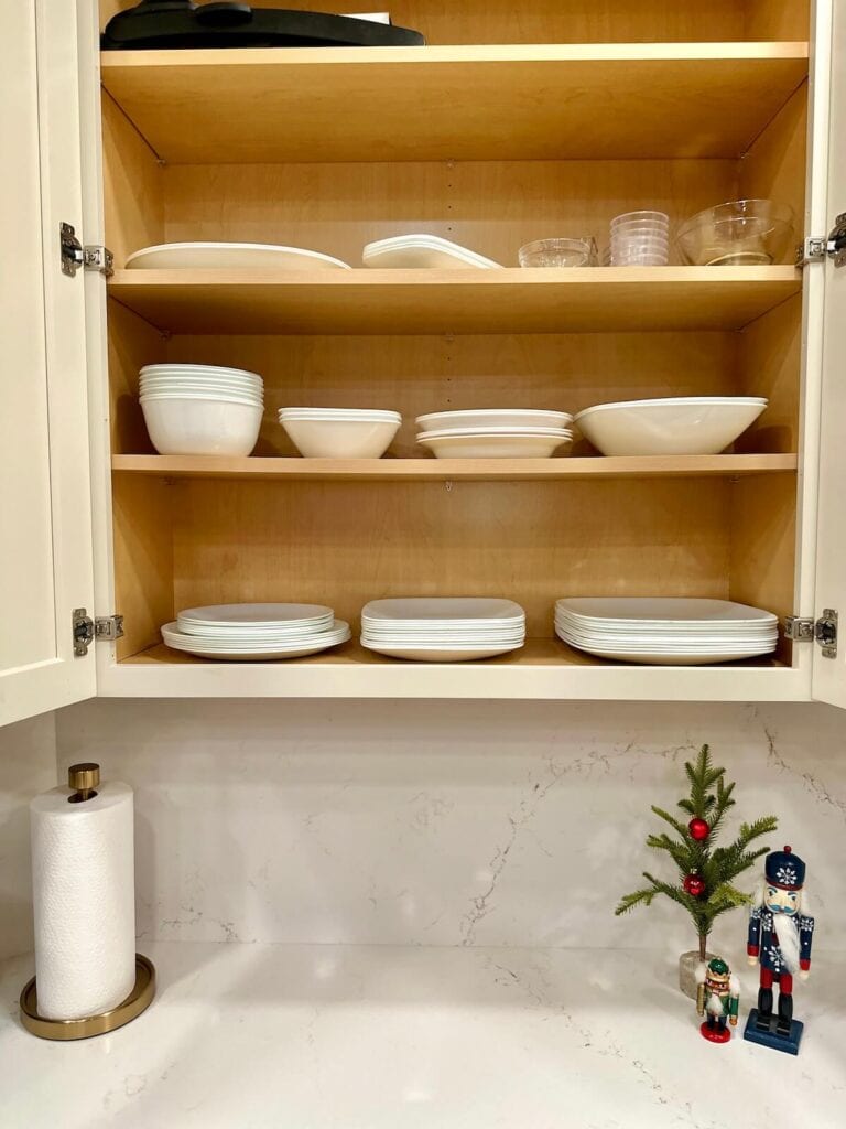 clutter free kitchen cabinet with plates and serving dishes