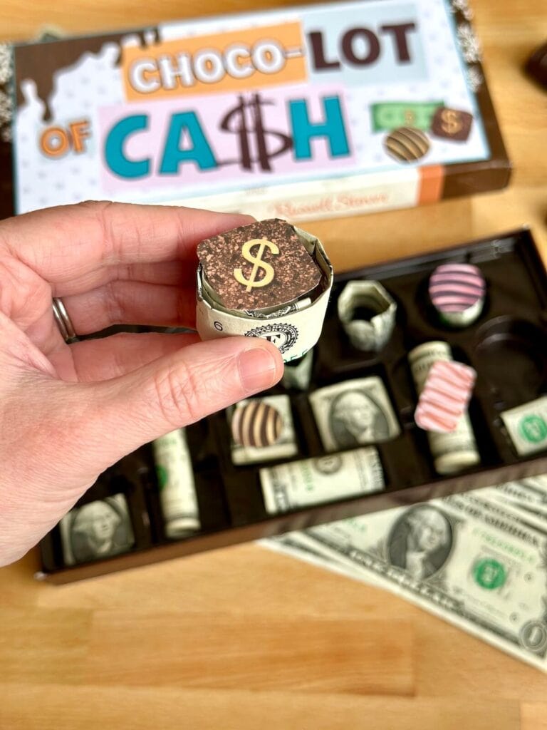 rolled up dollar bills in a box of chocolates