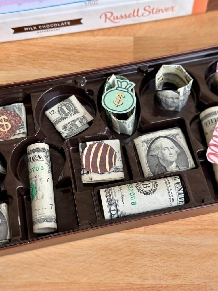 folded dollar bills in a chocolate box