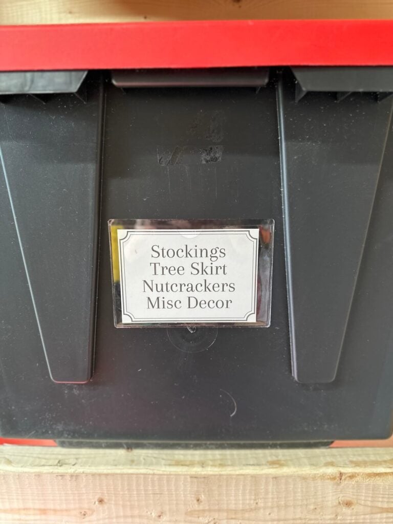 Christmas storage bin label that says stockings, tree skirt, nutcrackers