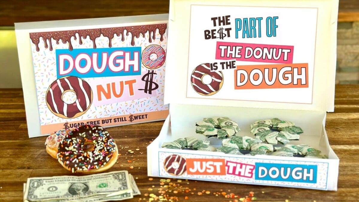 donut box money gift with folded dollar bills in the shape of donuts inside a donut box