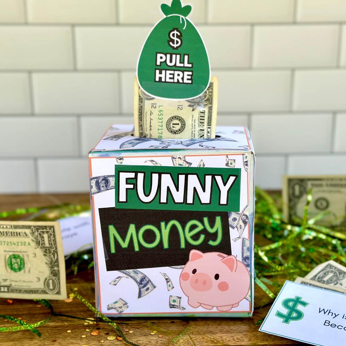 DIY tissue box money gift with printables that say "funny money" and dollar bill coming out of the top