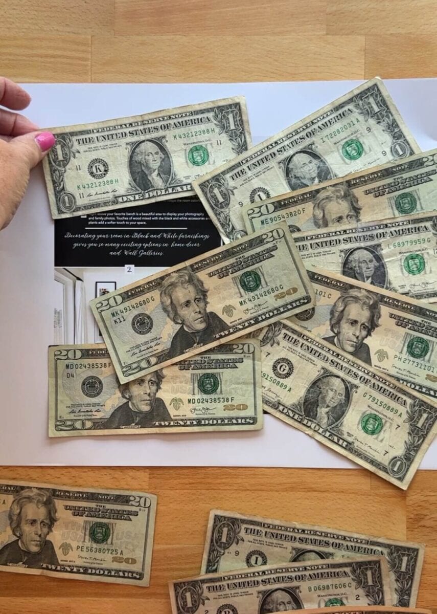 laying dollar bills out in a picture frame