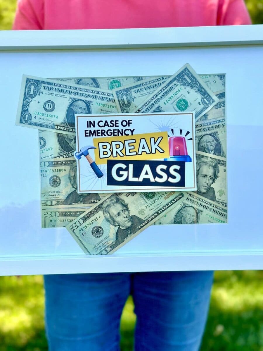 picture frame with money inside and a sign on top that says "in case of emergency break glass"