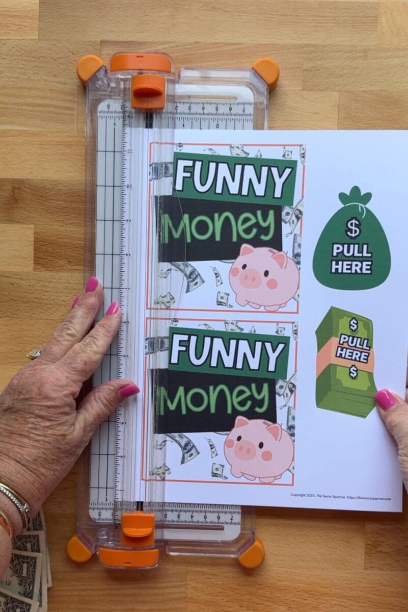 cutting out printable tags that say "funny money"