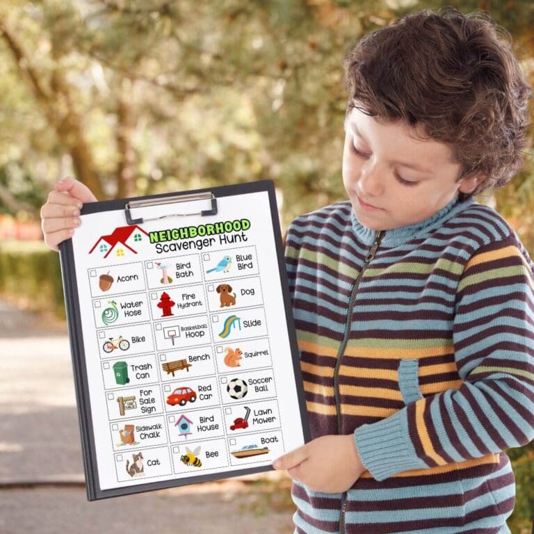 boy holding a clipboard outside with a neighborhood scavenger hunt paper