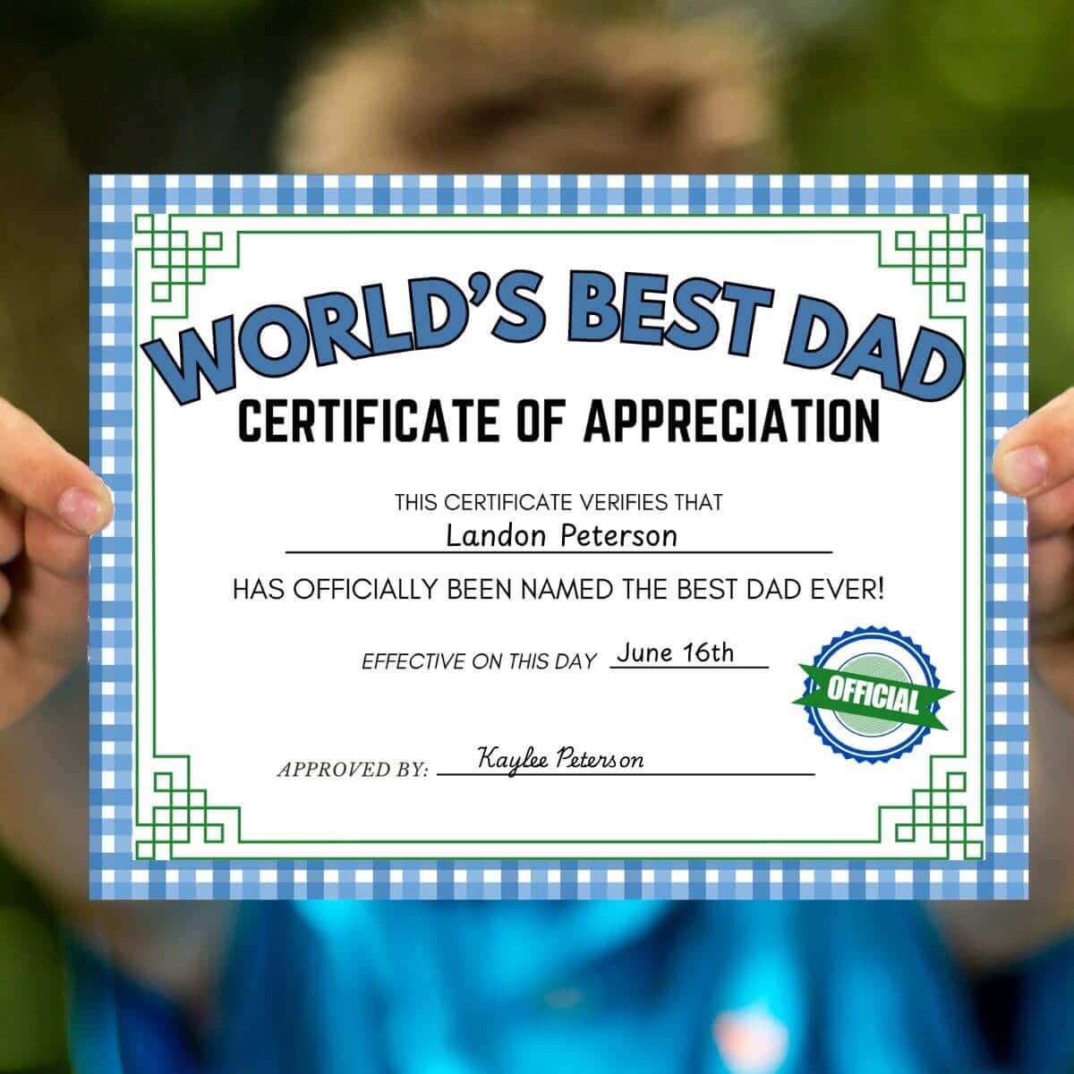 boy holding a certificate for the best dad
