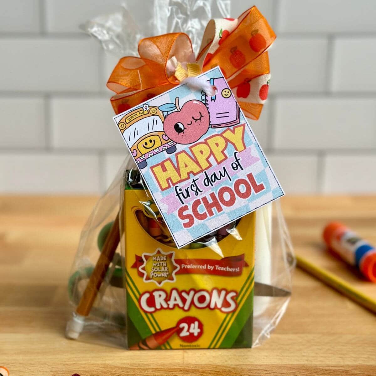 colorful back to school gift tag on a small bag of crayons and glue