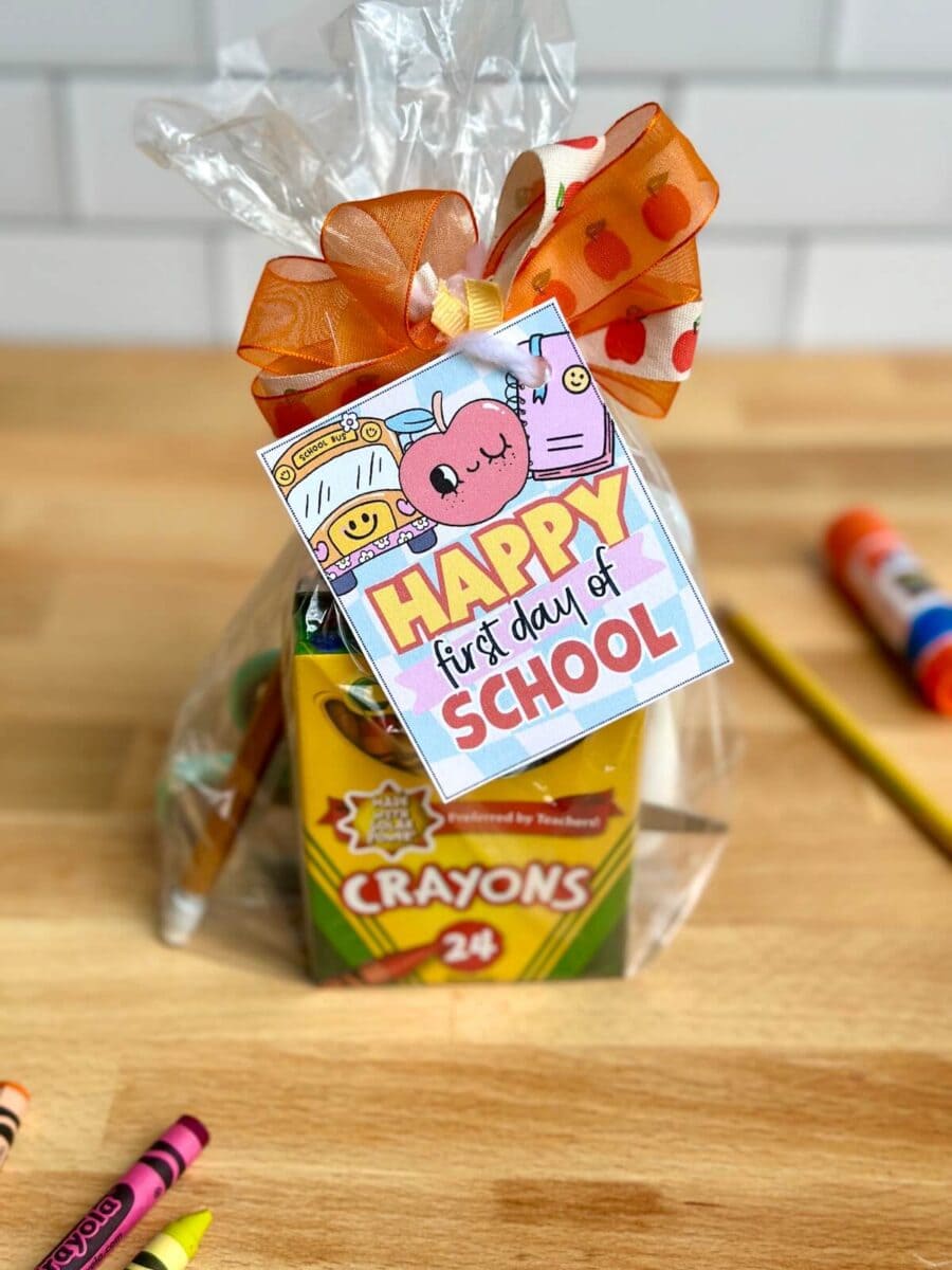 small gift bag with crayons and a gift tag that says "Happy first day of school"