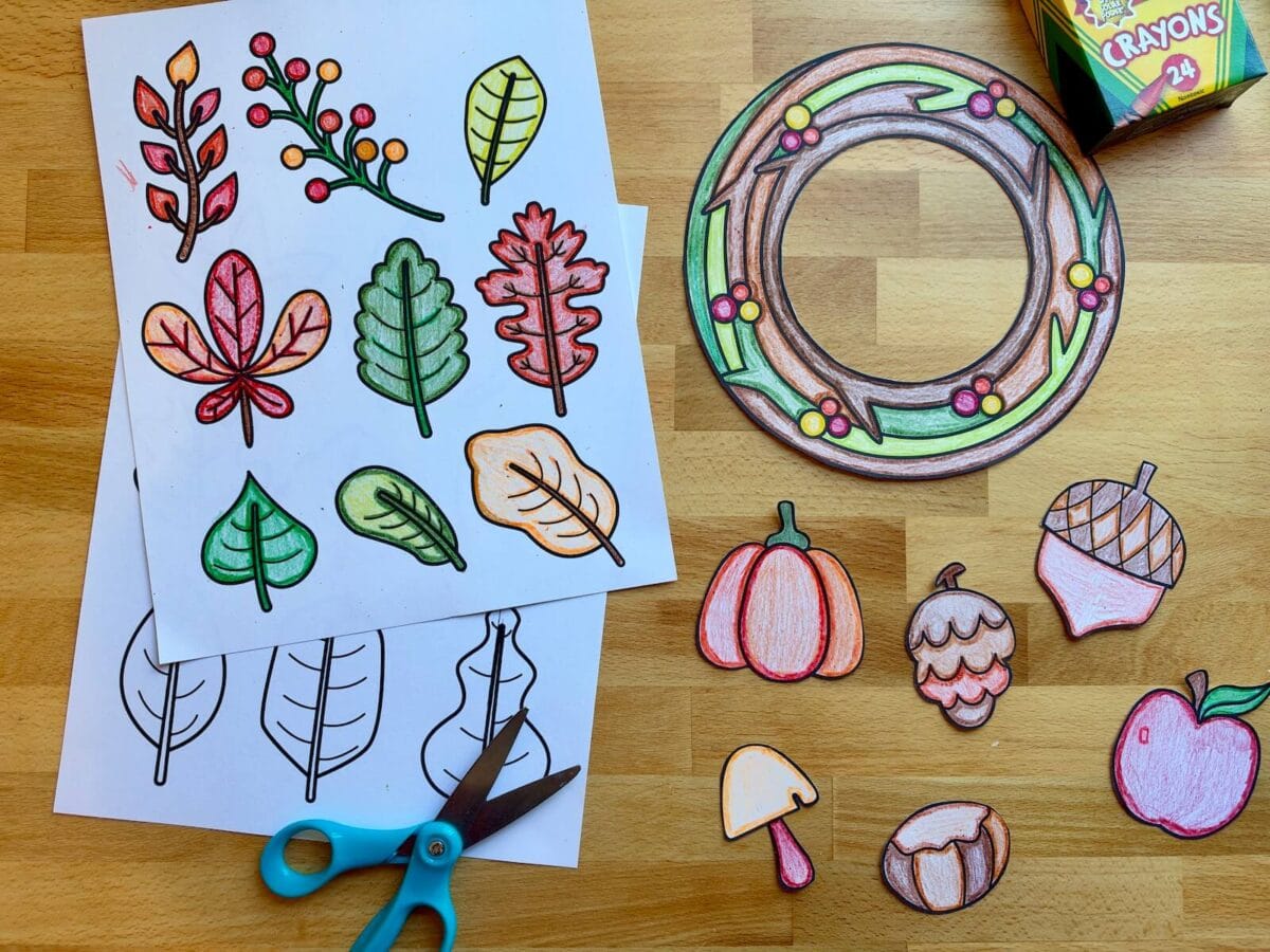 printable template with Fall leaves, berries, apples, and acorns colored with crayons and cut out