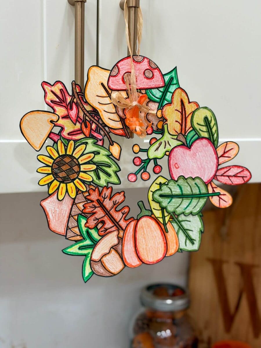 Fall wreath craft made with printable Fall leaves, pumpkins, acorns, and more Fall designs to color, cut, and paste